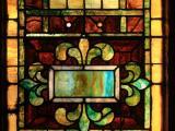 Small art glass window in need of restoration at St. Paul AME Church in Raleigh 